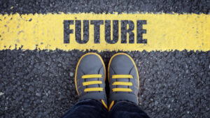 shows a person's shoes standing in front of yellow line with word future - live your life