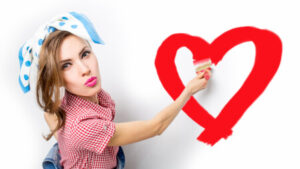 Woman Painting Heart on Whitewall - love yourself